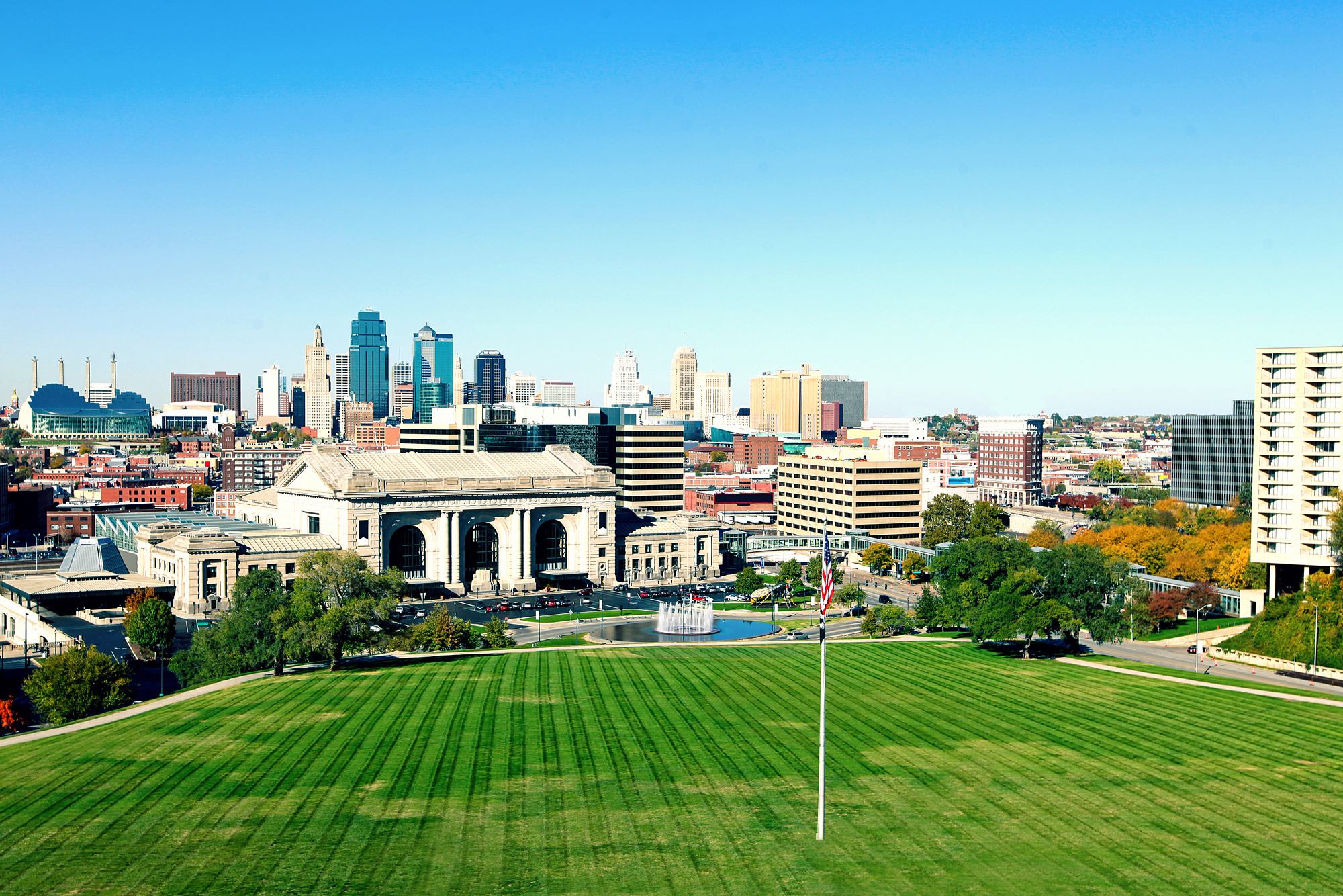 a view of the Kansas City skyline from the top of a hill