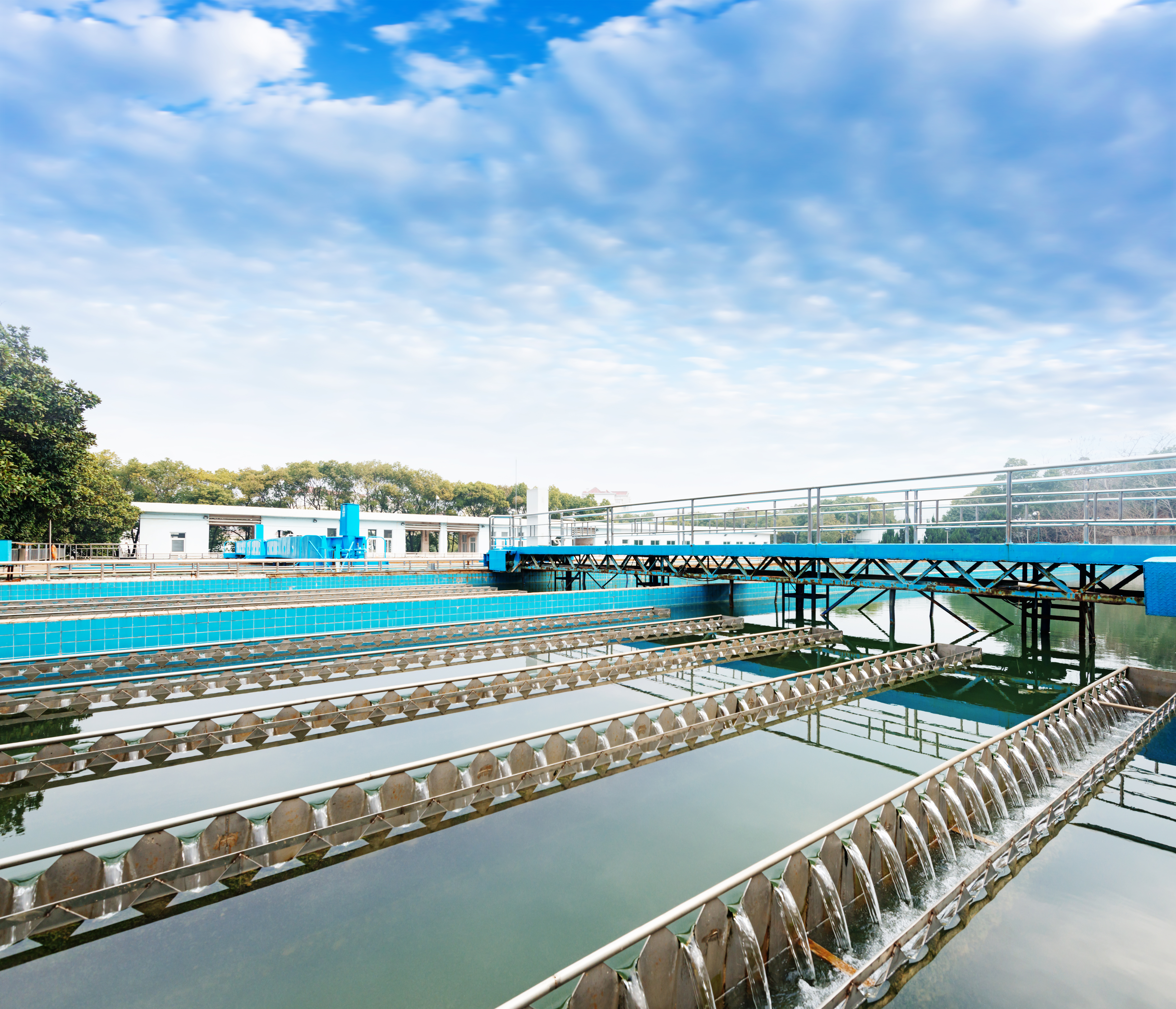 a large water treatment plant with a blue sky in the background